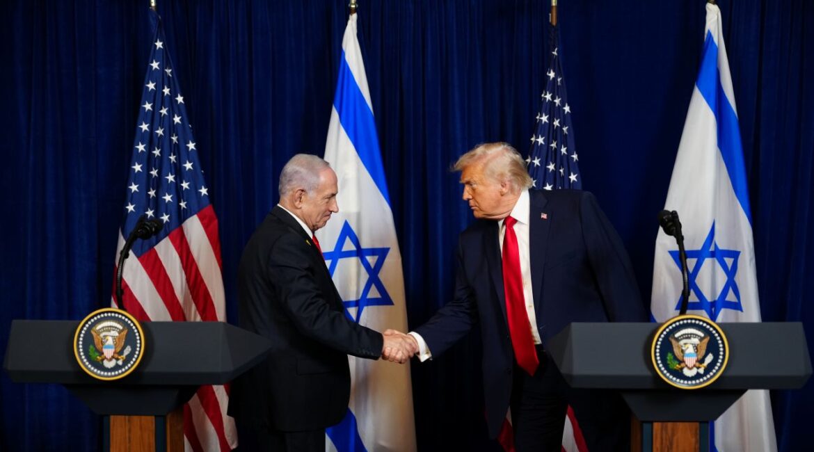 Image of Netanyahu and Trump shaking hands on a stage in front of US and Israeli flags