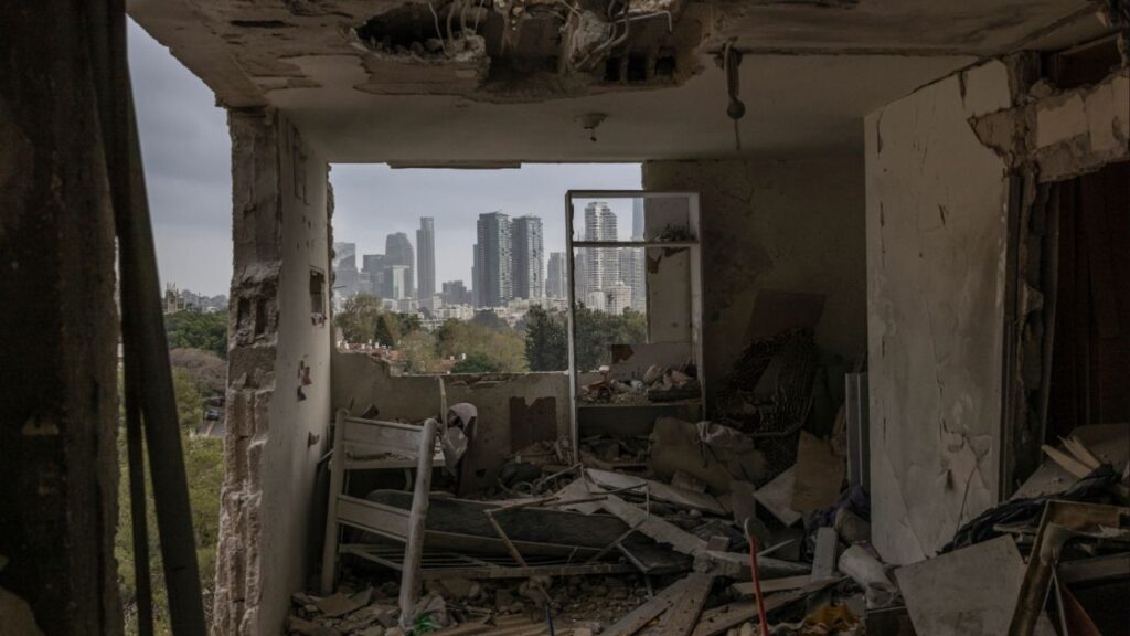 The Tel Aviv skyline is seen from an apartment damaged during an overnight Iranian missile attackl, on Thursday, March 19, 2026. The Trump administration said on Thursday that it was considering new steps as it scrambles to avert a sustained energy crisis set off by the U.S.-Israeli war against Iran. (Avishag Shaar-Yashuv/The New York Times)