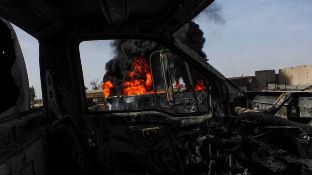 Thick black smoke is seen through a destroyed truck at the private airline Kam Air's fuel depot after a strike in what the Taliban said was a Pakistani air strike, in Kandahar, Afghanistan, March 13, 2026. (Reuters/Stringer)