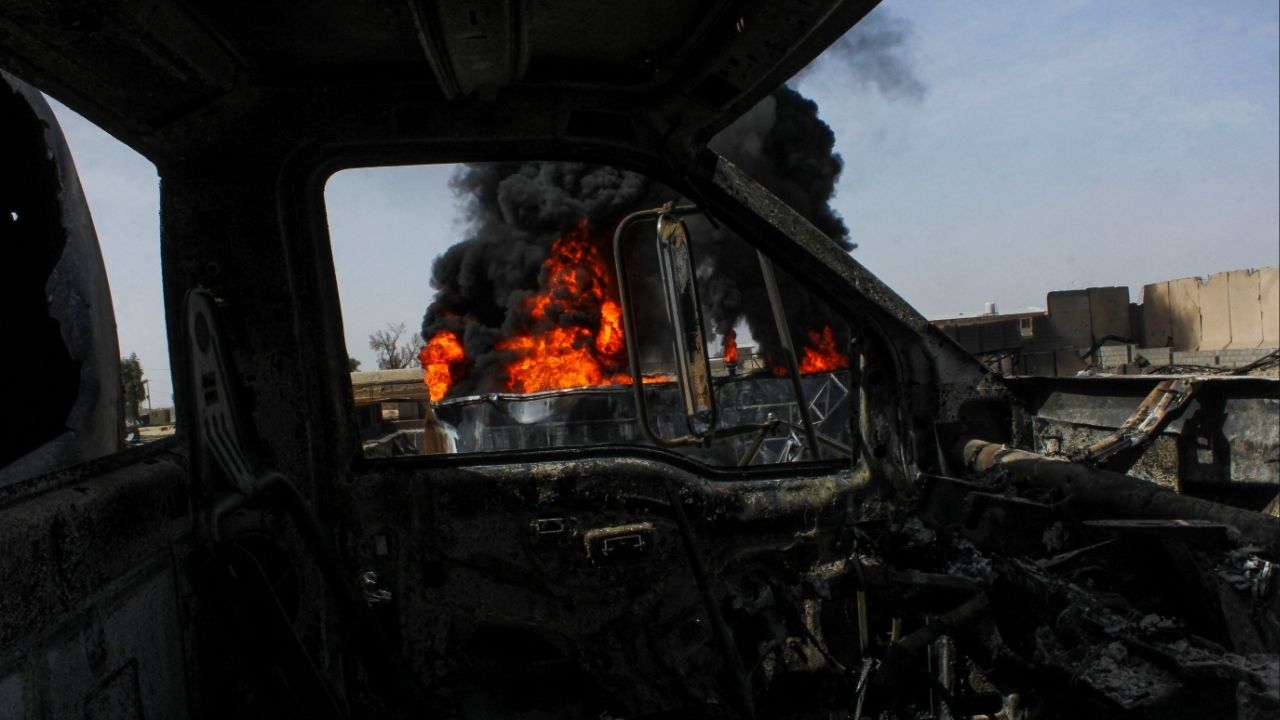 Thick black smoke is seen through a destroyed truck at the private airline Kam Air's fuel depot after a strike in what the Taliban said was a Pakistani air strike, in Kandahar, Afghanistan, March 13, 2026. (Reuters/Stringer)