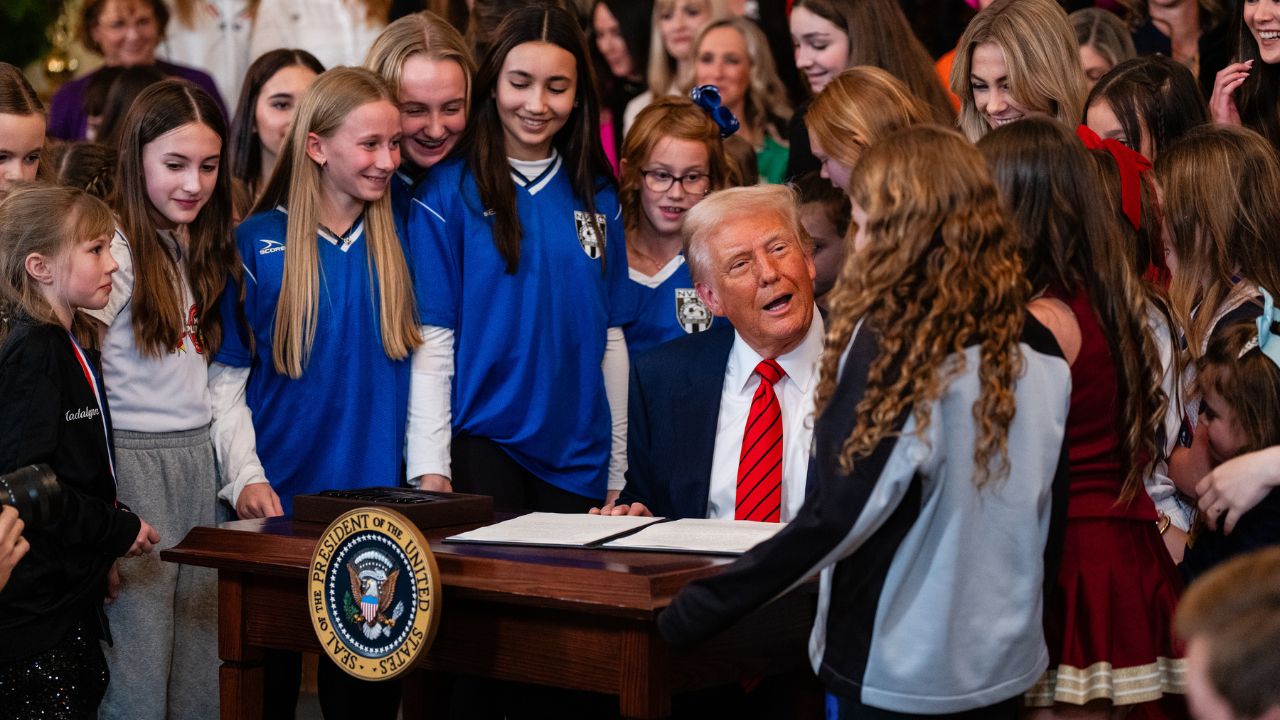 President Donald Trump with young female athletes as signs an executive order that barred transgender athletes from competing in girl’s and women’s athletics, in the East Room of the White House in Washington, Feb. 5, 2025. The Trump administration sued the Minnesota Education Department and the state group in charge of interscholastic athletics on Monday, March 30, 2026, accusing both of violating civil rights protections for girls by allowing transgender students to participate on girls’ sports teams. (Eric Lee/The New York Times)