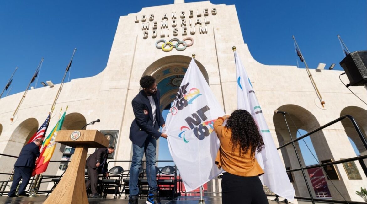Workers from LA28 setup Olympic and Paralympic flags outside the Los Angeles Coliseum in Los Angeles, California, U.S., May 8, 2025. (Reuters File)