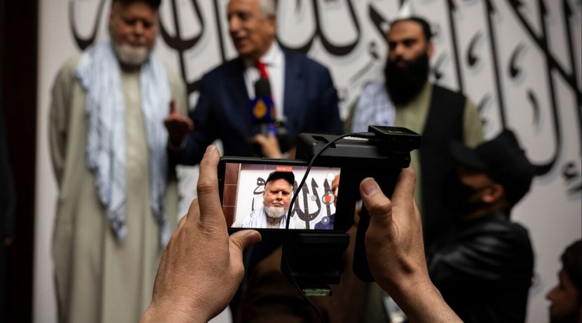 Zalmay Khalilzad, the former U.S. special envoy to Afghanistan, speaks to reporters upon the release of the American researcher Dennis Coyle, left, in Kabul on Tuesday, March 24, 2026. Afghanistan’s Taliban-led government on Tuesday freed Coyle, who had been held there for over a year, amid pressure from the Trump administration to release Americans who it says are being held without justification. (Kiana Hayeri/The New York Times)