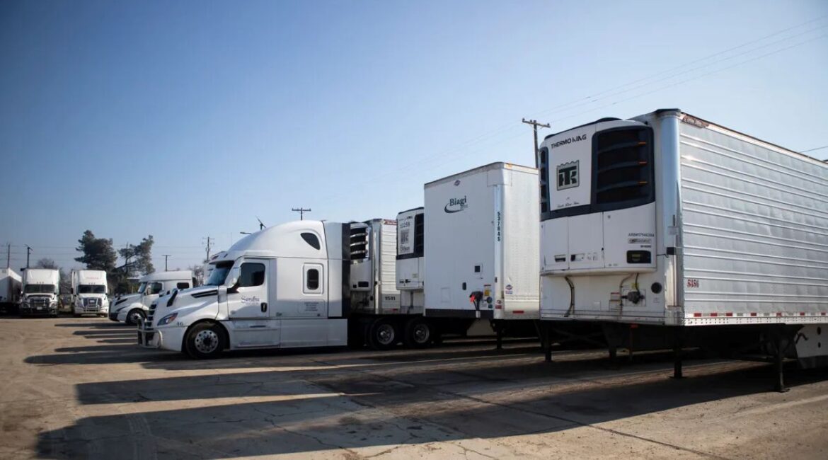 Image of long haul freight trucks in a company yard