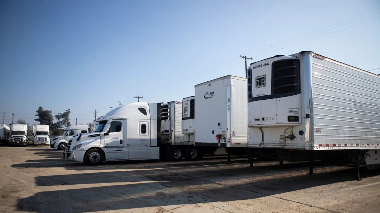Image of long haul freight trucks in a company yard