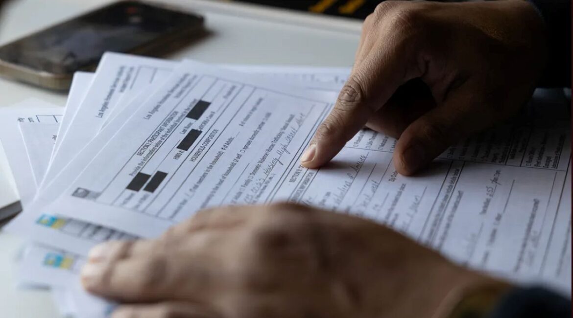 Image of hands on a public document, symbolizing someone reading it carefully