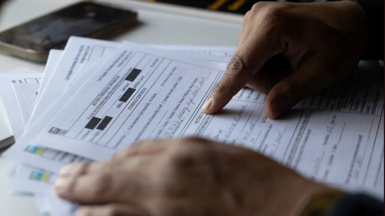 Image of hands on a public document, symbolizing someone reading it carefully