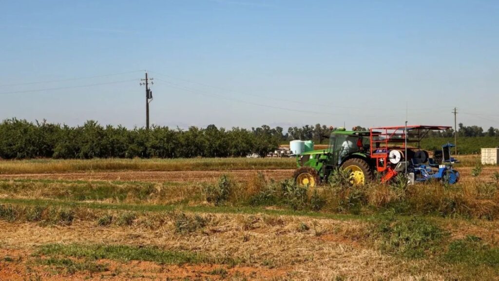 Image of a student discing a field at UC Merced "smart farm"