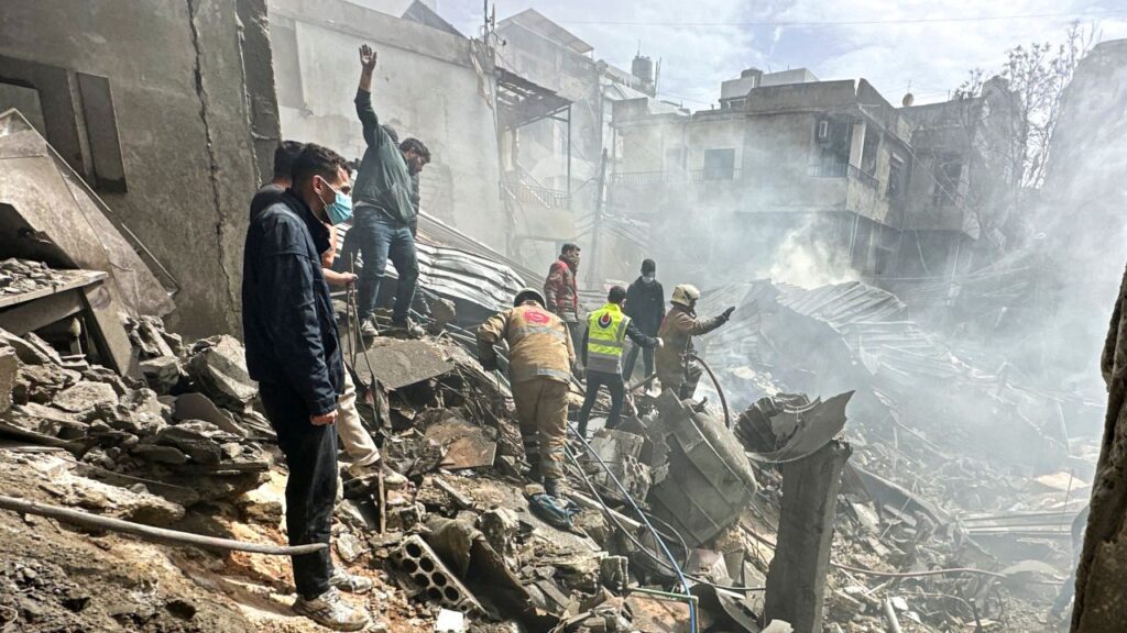Resident inspect the damage done by an Israeli airstrike in Lebanon