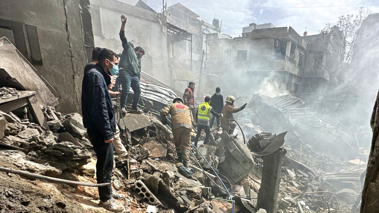 Resident inspect the damage done by an Israeli airstrike in Lebanon
