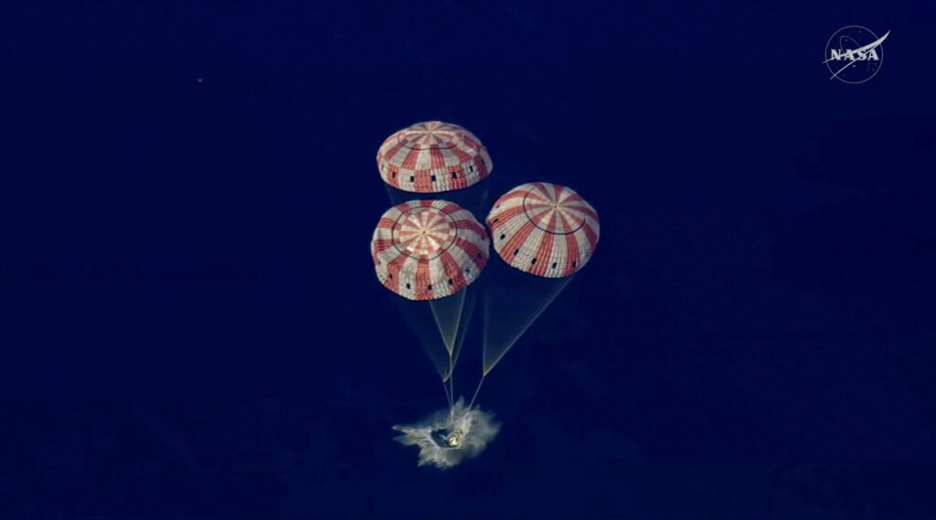 Image of the Artemis II capsule splashing down in the Pacific Ocean