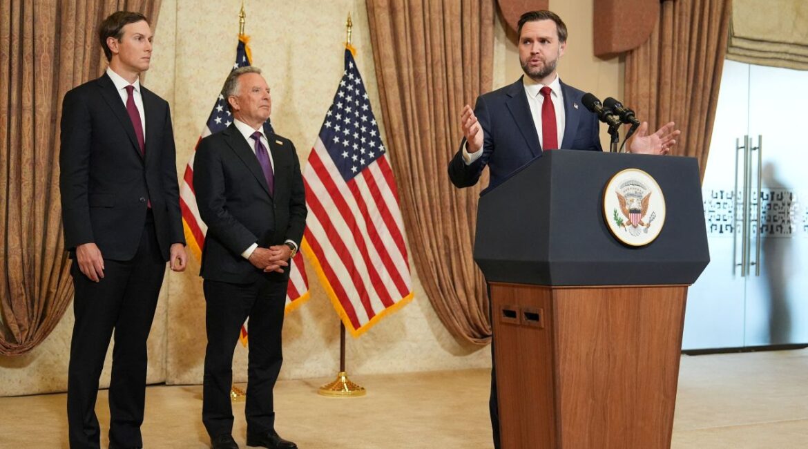 Image of VP JD Vance speaking at a podium with Jared Kushner and Steve Witikoff in the room. There are American flags in the background