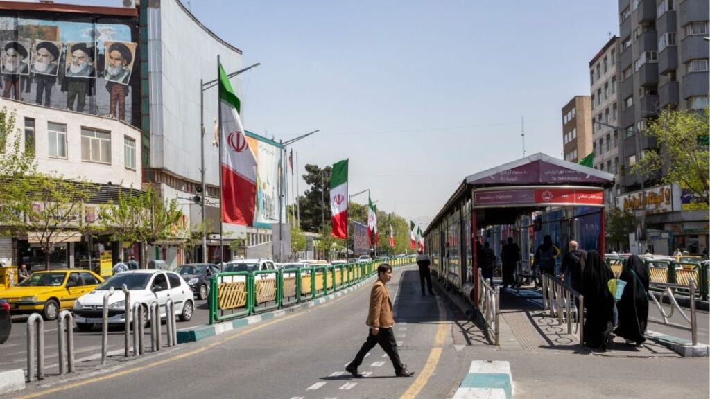 A man crosses Enghelab Street near a bus stop in Tehran, April 5, 2026. Iran on Wednesday, April 15, threatened further retaliation over an American naval blockade of its ports in the critical Strait of Hormuz as the U.S. military said that it had “completely halted” trade in and out of Iran by sea. (Arash Khamooshi/The New York Times)