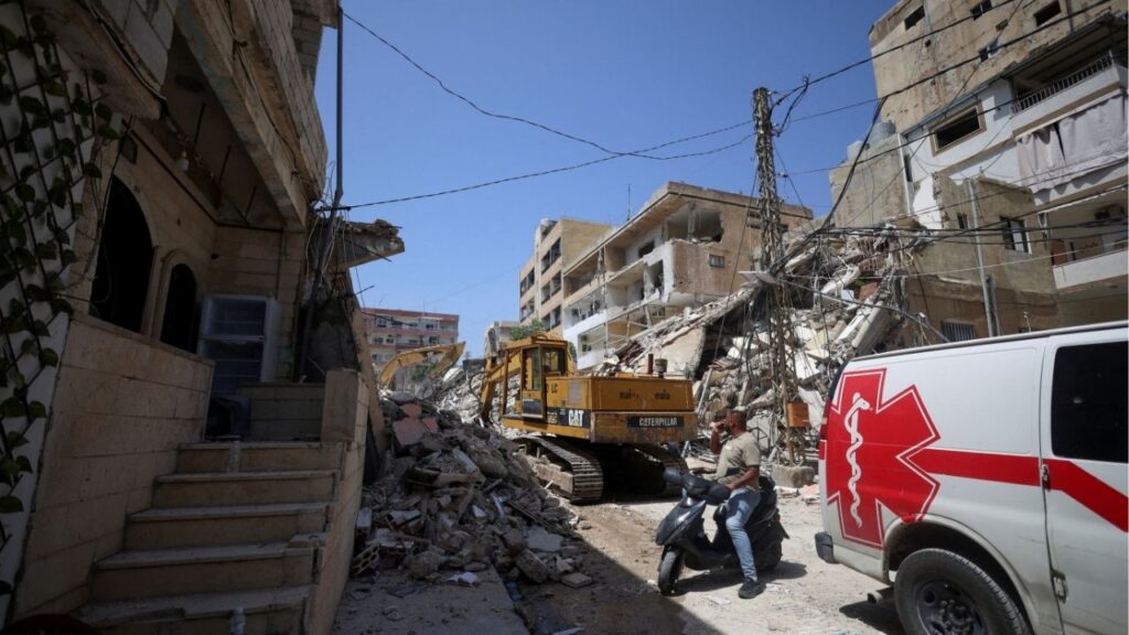A man next to an ambulance looks at the site of an Israeli strike carried out before a 10-day ceasefire between Lebanon and Israel went into effect, in Tyre, Lebanon, April 17, 2026. (Reuters/Louisa Gouliamaki)