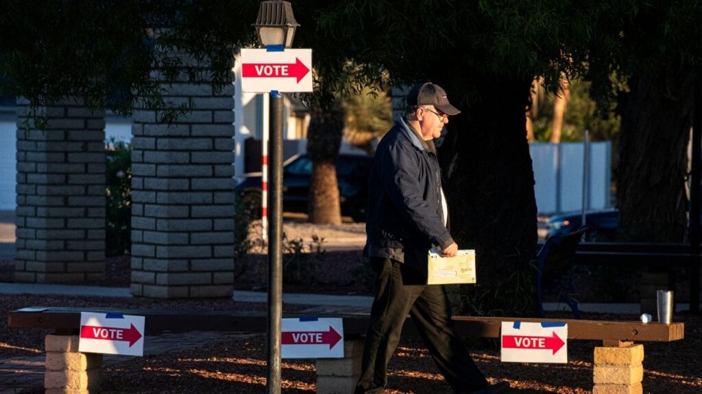 A man walks into a voting center with his mail-in ballot at Emmanuel Presbyterian Church, on Election Day, in Phoenix, Arizona, U.S., November 5, 2024. (Reuters/Caitlin O'Hara)