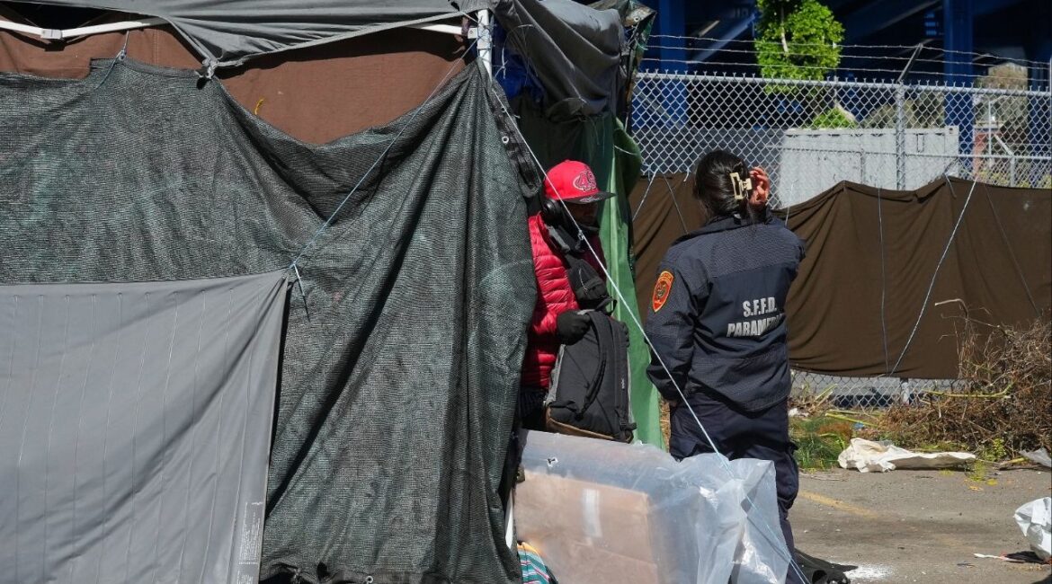 A paramedic speaks with a homeless man in San Francisco, Aug. 1, 2024. A federal judge on Tuesday, March 31, 2026, ruled that the Trump administration had illegally demanded that groups seeking homelessness grants comply with its agenda on immigration enforcement, transgender rights and other unrelated issues. (Jim Wilson/The New York Times)