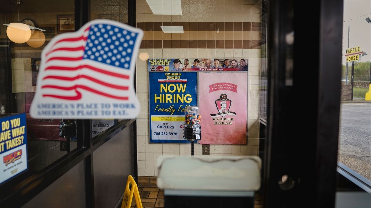 A view through a glass doorway at the Waffle House on Martha Berry Highway in Rome, Ga., April 2, 2026. Gregg Phillips, the Federal Emergency Management Agency (FEMA) official in charge of responding to fires and floods, says the hand of God suddenly and mysteriously moved him to the 24-hour breakfast spot. (Nicole Craine/The New York Times)