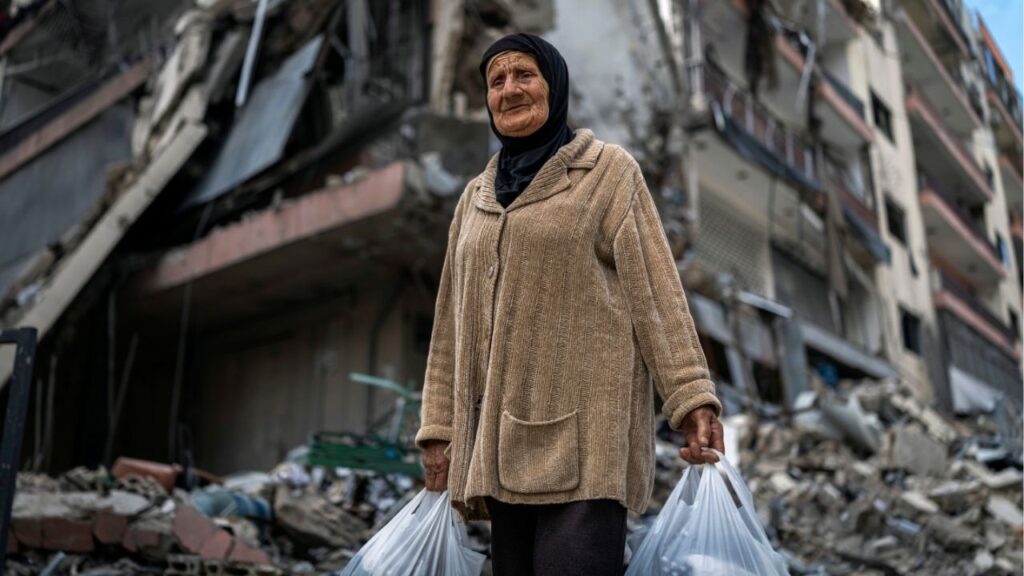 A woman displaced by the fighting near her home in Marjayoun, Lebanon, carries belongings in plastic bags in Dahiyeh, a suburb south of Beirut, on Friday, April 17, 2026. A 10-day ceasefire between Israel and Lebanon went into effect on Friday, potentially removing a major stumbling block in the ongoing peace talks between the United States and Iran. (Diego Ibarra Sanchez/The New York Times)