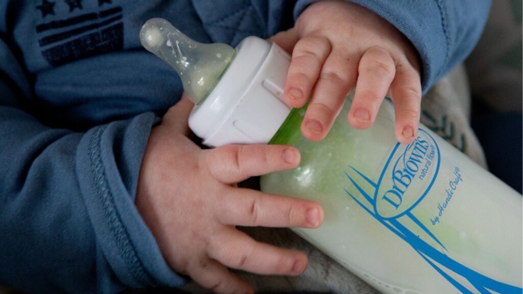 An infant is fed formula from a bottle in Plymouth, Mass., on Sunday, May 15, 2022. The Food and Drug Administration said the analysis of more than 300 formula samples was reassuring, but outside experts raised some concerns. (Kayana Szymczak/The New York Times)