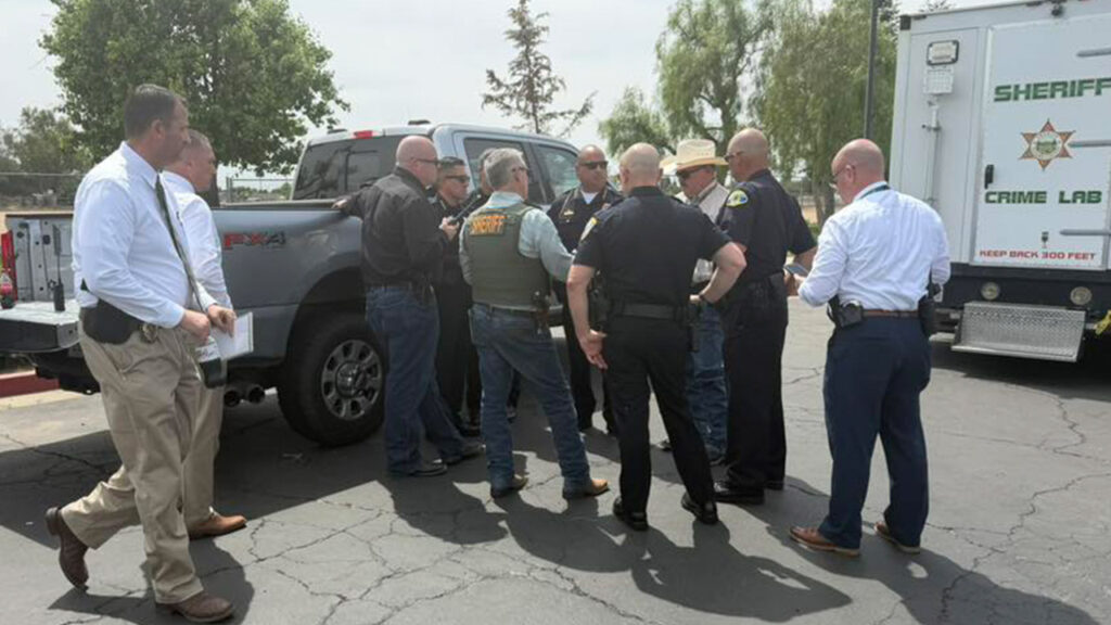 Image of law enforcement at a command post reacting to the shooting death of a Tulare County sheriff's deputy.