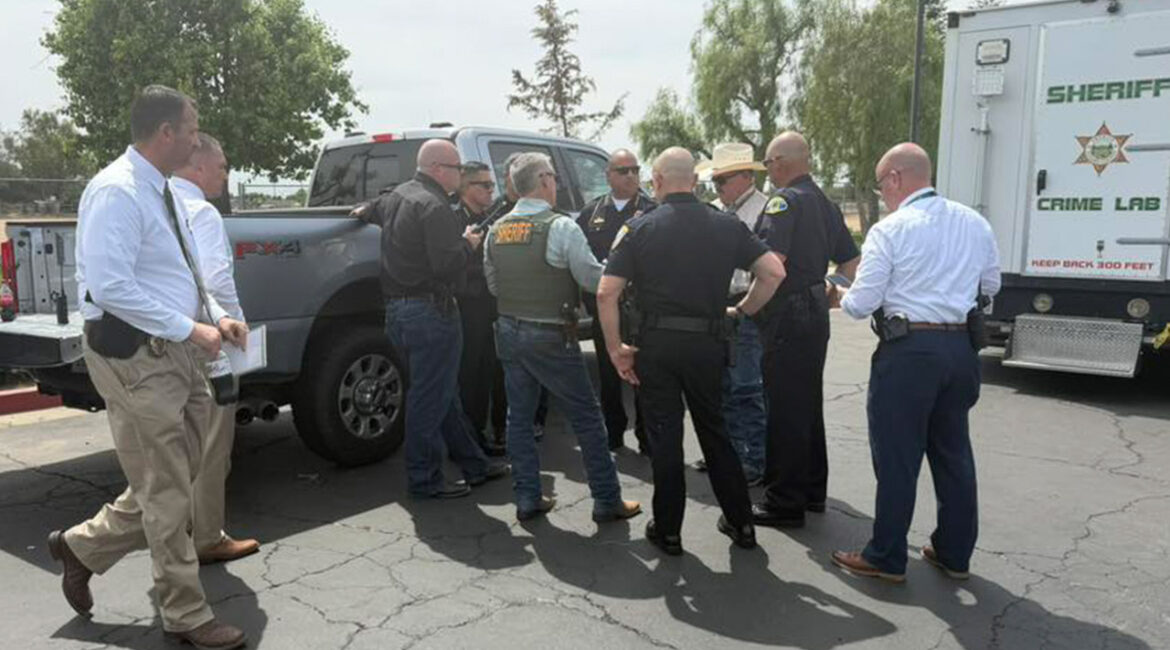 Image of law enforcement at a command post reacting to the shooting death of a Tulare County sheriff's deputy.