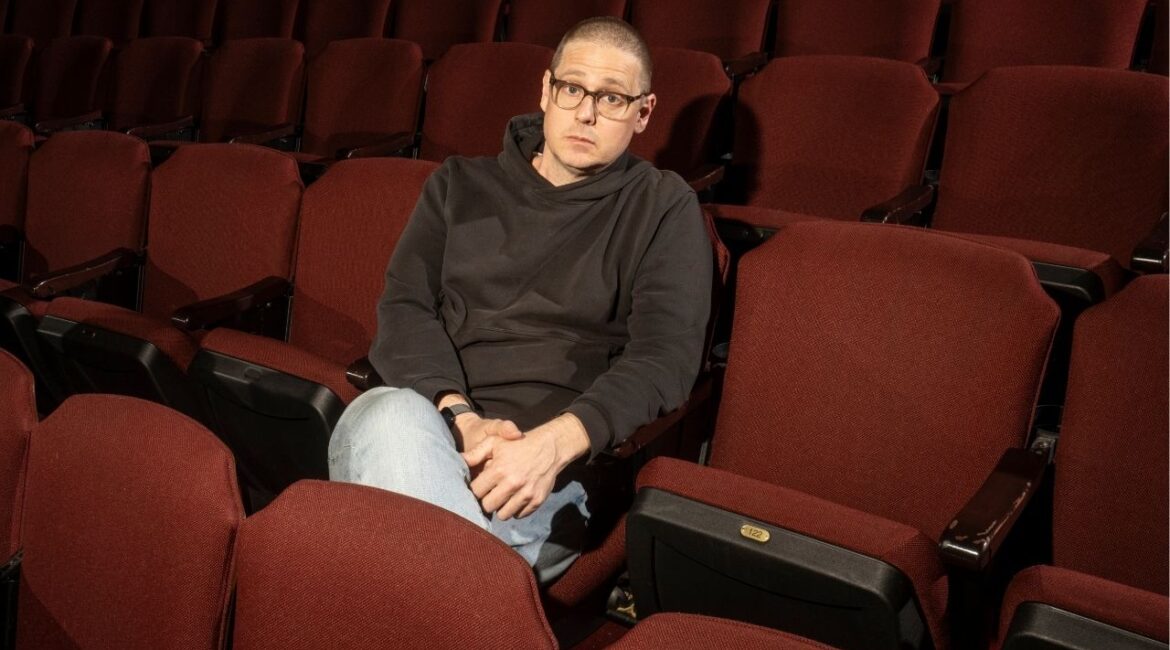 Comedian Tim Heidecker at Kings Theatre in Brooklyn on April 4, 2026. Tim Heidecker, one of the comedians behind “Tim and Eric Awesome Show, Great Job!” has been hired by The Onion to serve as “creative director of Infowars.” (Alexander Coggin/The New York Times)
