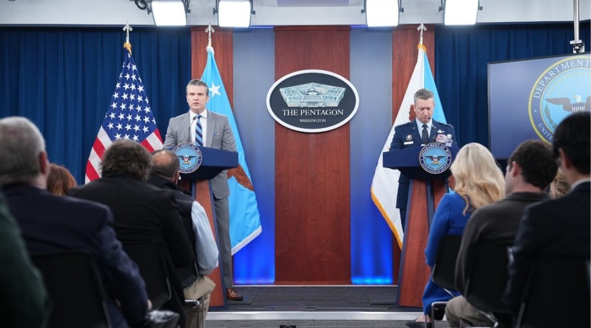 Defense Secretary Pete Hegseth, left, and Gen. Dan Caine, chairman of the Joint Chiefs of Staff, give a briefing on the Iran conflict at the Pentagon in Arlington, Va. on Friday, April 24, 2026. The U.S. Navy blockade of Iranian ships and ports will continue for “as long as it takes,” Hegseth said here. Iran has made lifting the blockade a condition of resuming peace talks with Washington. (Eric Lee/The New York Times)