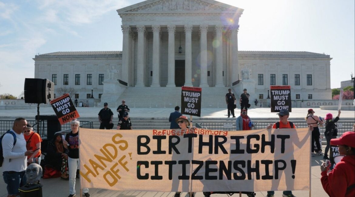 Demonstrators hold signs outside the U.S. Supreme Court building on the day the court is expected to hear oral arguments on the legality of the Trump administration's effort to limit birthright citizenship for the children of immigrants, in Washington, D.C., U.S., April 1, 2026. (Reuters/Kylie Cooper)