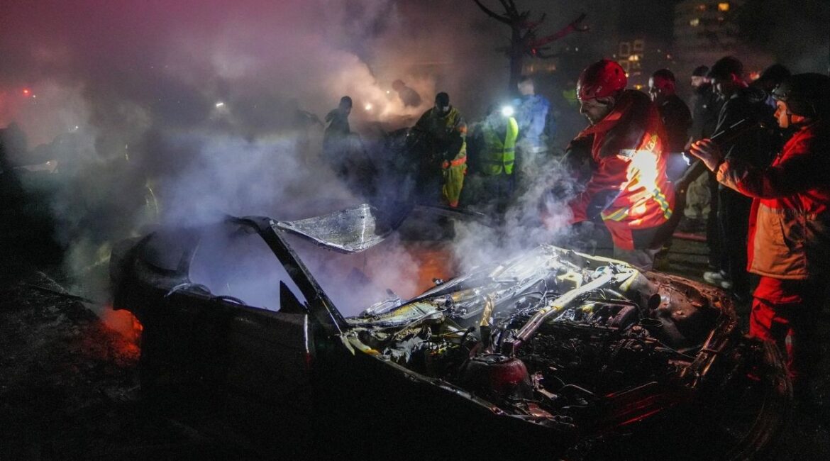 Emergency personnel operate around a destroyed car following a targeted Israeli strike, amid escalating hostilities between Israel and Hezbollah, as the U.S.-Israel conflict with Iran continues, in Beirut, Lebanon, March 31, 2026. (Reuters/Stringer)
