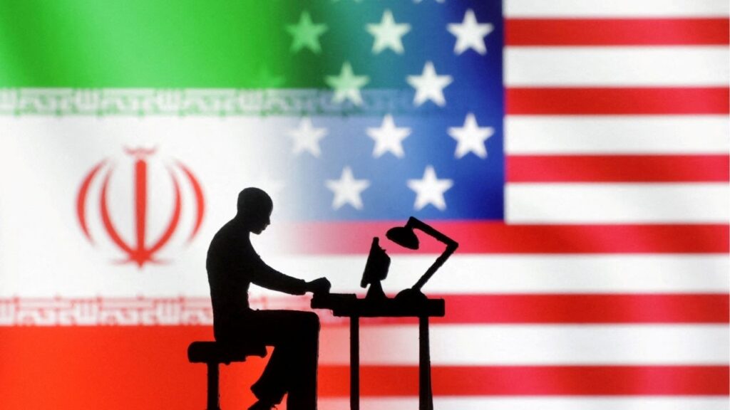 Figurines with computers are seen in front of USA and Iran flags in this illustration created on September 10, 2022. (Reuters File)