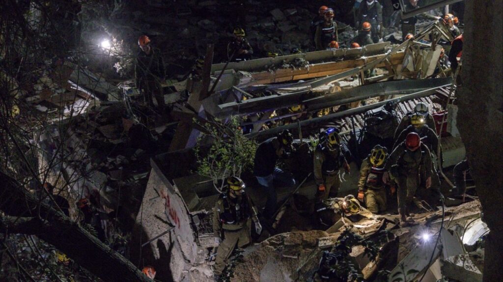 First responders at the scene of a residential building that was struck during an Iranian missile attack in Haifa, Israel, on Sunday, April 5, 2026. Israeli rescue workers on Monday recovered the last of four bodies that were trapped overnight in the ruins of a residential building in the northern Israeli port city of Haifa, a full 18 hours after an Iranian missile crashed into it. (Avishag Shaar-Yashuv/The New York Times)