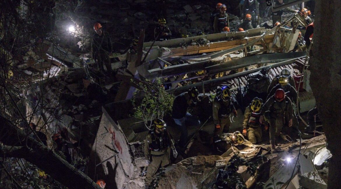 First responders at the scene of a residential building that was struck during an Iranian missile attack in Haifa, Israel, on Sunday, April 5, 2026. Israeli rescue workers on Monday recovered the last of four bodies that were trapped overnight in the ruins of a residential building in the northern Israeli port city of Haifa, a full 18 hours after an Iranian missile crashed into it. (Avishag Shaar-Yashuv/The New York Times)