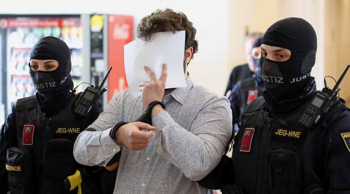One of the two men suspected of being Islamic State (IS) supporters, who were planning an attack on Taylor Swift's Vienna concert in 2024, covers his face as he returns in a courtroom for their trial in Wiener Neustadt, Austria, April 28, 2026. (Reuters/Leonhard Foeger)