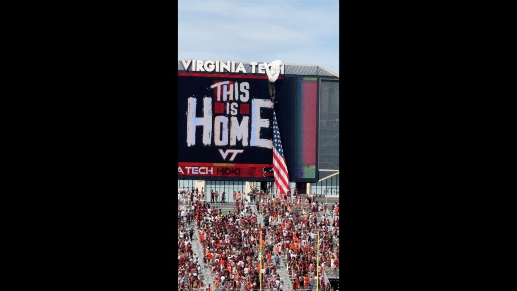 A Parachuter gets stuck on the scoreboard at Virginia Tech's spring game after strong winds pushed the parachute off its landing path, in Blacksburg, Virginia, U.S., April 18, 2026 in this screengrab taken from a social media video. (Charlz Chalmers/via REUTERS)