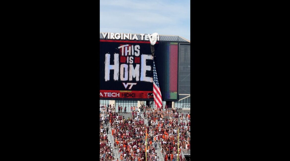 A Parachuter gets stuck on the scoreboard at Virginia Tech's spring game after strong winds pushed the parachute off its landing path, in Blacksburg, Virginia, U.S., April 18, 2026 in this screengrab taken from a social media video. (Charlz Chalmers/via REUTERS)