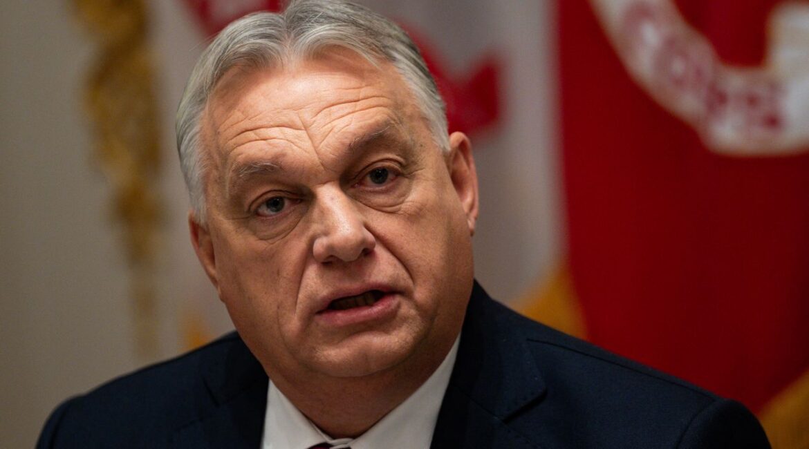 Image of Prime Minister Viktor Orban of Hungary. He's in a dark suit with a white shirt and red tie