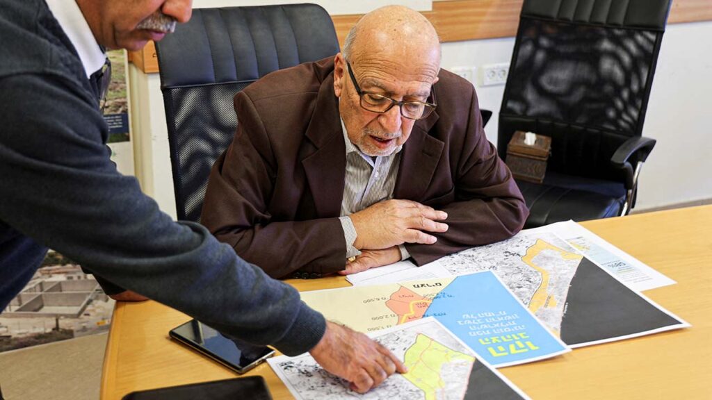 The Director General of the Applied Research Institute-Jerusalem (ARIJ), Dr. Jad Isaac, looks at maps of Gaza during an interview with Reuters in Bethlehem, in the Israeli-occupied West Bank, April 28, 2026. (Reuters/Mustafa Abu Ganeyeh)