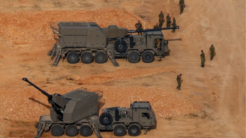 Israeli soldiers next to artillery vehicles near the Israel-Lebanon border, in northern Israel, April 15, 2026. REUTERS/Florion Goga