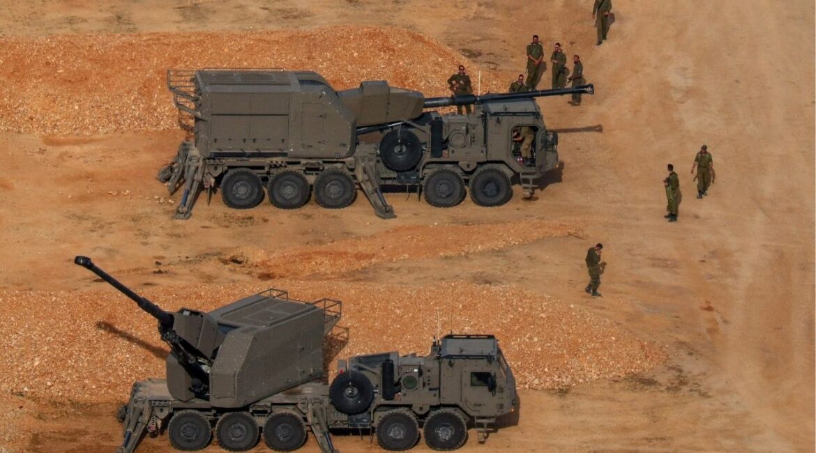 Israeli soldiers next to artillery vehicles near the Israel-Lebanon border, in northern Israel, April 15, 2026. REUTERS/Florion Goga