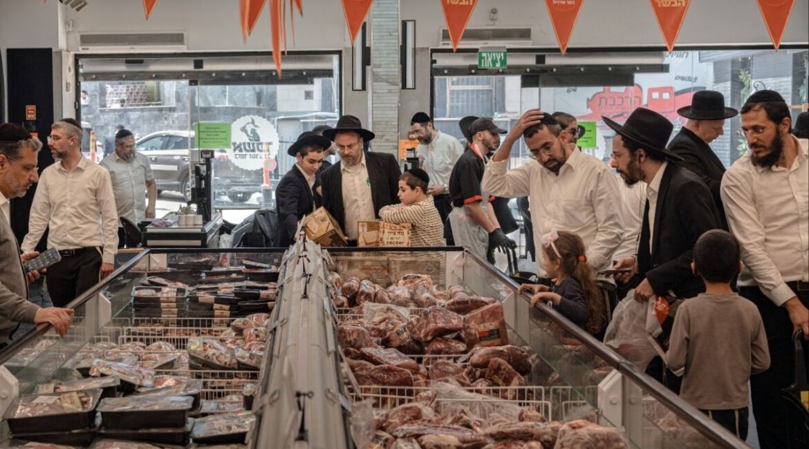Local residents stock up on food ahead of the Passover holidays in Bnei Brak, Israel, on Tuesday, March 31, 2026. The atmosphere during preparations for the Jewish festival has been unusually subdued, with people afraid to stray far from their homes and shelters. (Amit Elkayam/The New York Times)