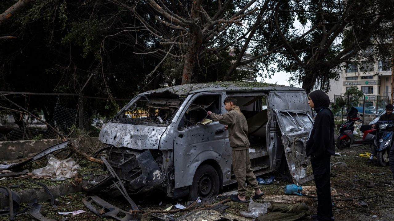 Local youths examine the wreckage of a vehicle after an airstrike in Beirut, Lebanon, that killed at least five overnight on Wednesday, April 1, 2026. There were more Israeli strikes across southern Lebanon on Wednesday, a day after Israel said it plans to occupy and control a large swath of the region and demolish entire towns. Lebanon’s national news agency reported airstrikes in several towns. (Diego Ibarra Sánchez/The New York Times)