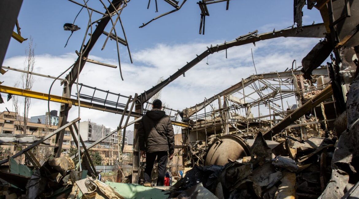 Image of a man inspecting damage in Tehran after a U.S.-Israeli missile strike