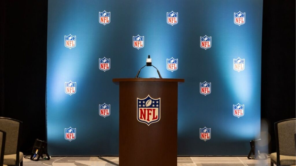Mar 30, 2026; Phoenix, AZ, USA; Detailed view of the NFL shield logo on a lectern in a press conference room during the 2026 NFL Annual League Meeting at the Arizona Biltmore. Mandatory Credit: Mark J. Rebilas-Imagn Images