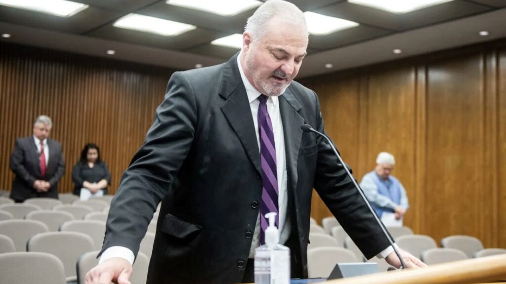 Image of Steve Hammond, with his head bowed, delivering an invocation at the Merced County Board of Supervisors