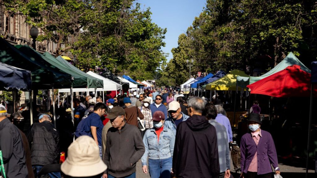 Image of the Old Oakland Farmers Market on a crowded tree-lined street