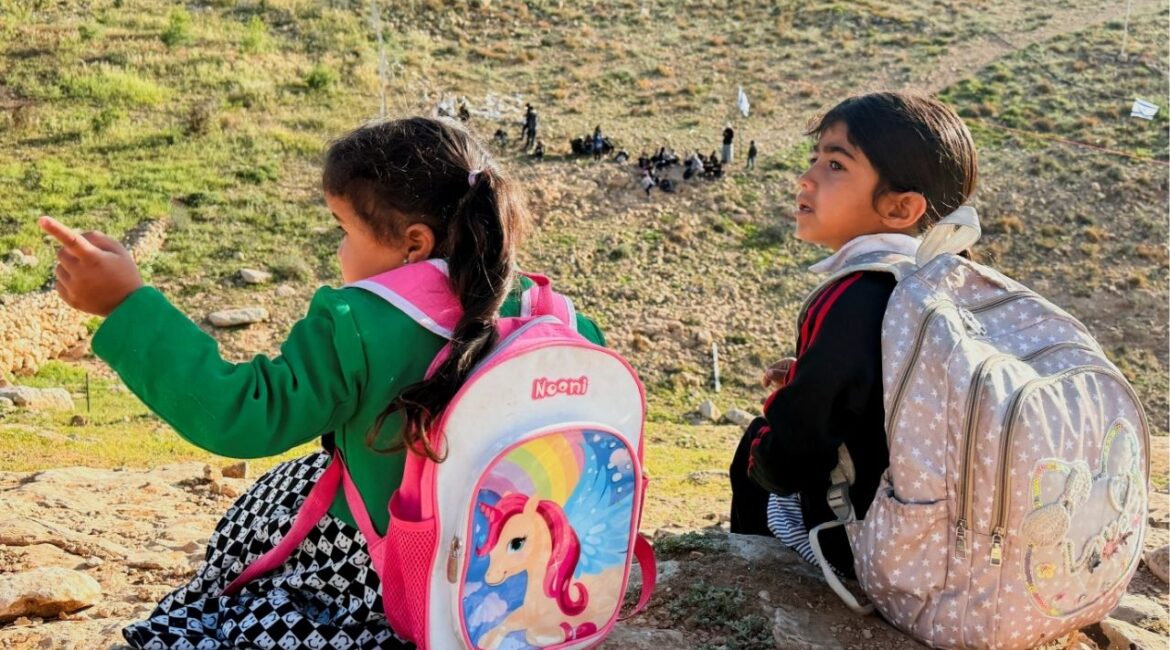 Palestinian students gather near a fence installed by Israeli settlers in their way to school, near Umm al-Khair village in Masafer Yatta, in the Israeli-occupied West Bank, April 14, 2026. Picture taken with a mobile phone. (Reuters/Yosri Aljamal)