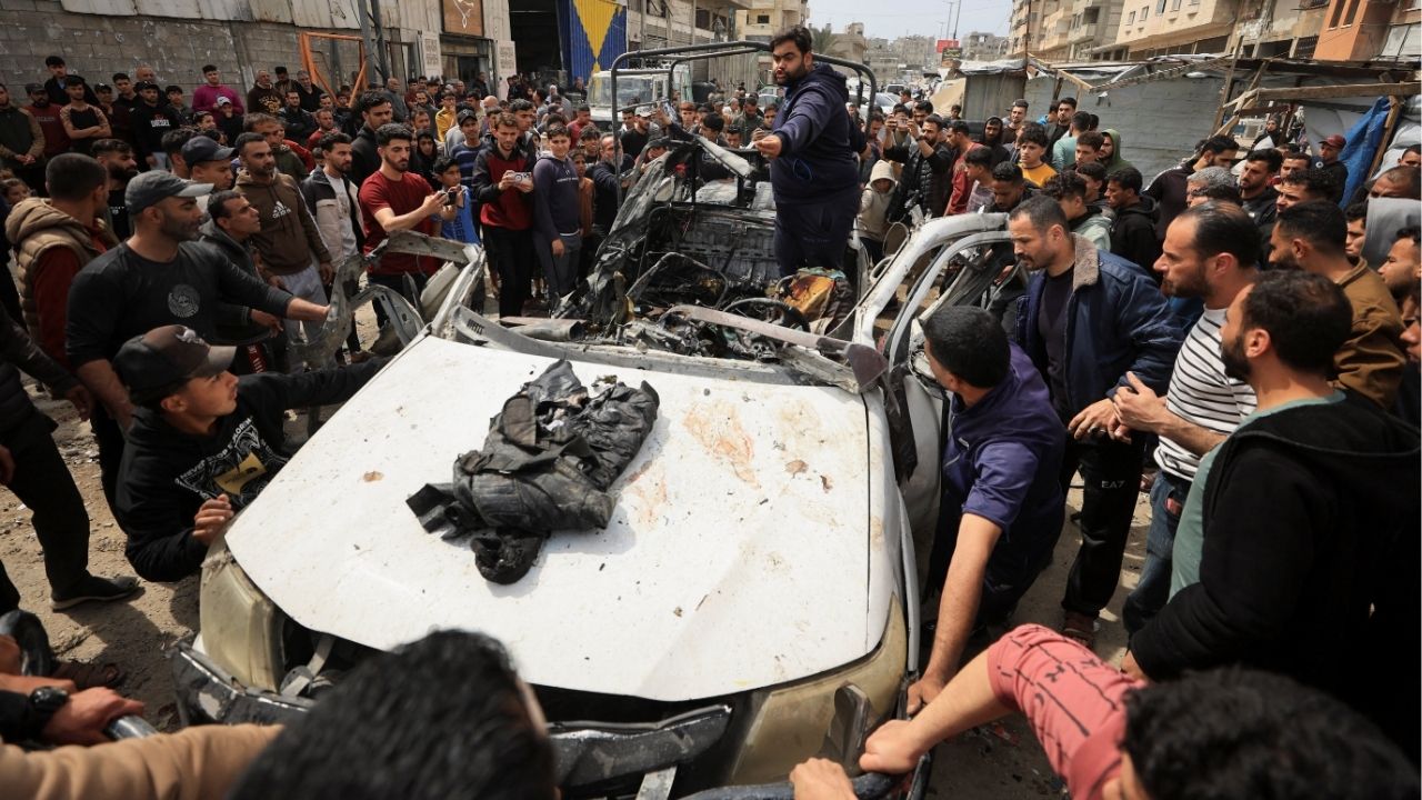 Palestinians inspect the damage after an Israeli strike targeted a police vehicle in Gaza City, according to medics, in Gaza City, April 14, 2026. (Reuters/Dawoud Abu Alkas)