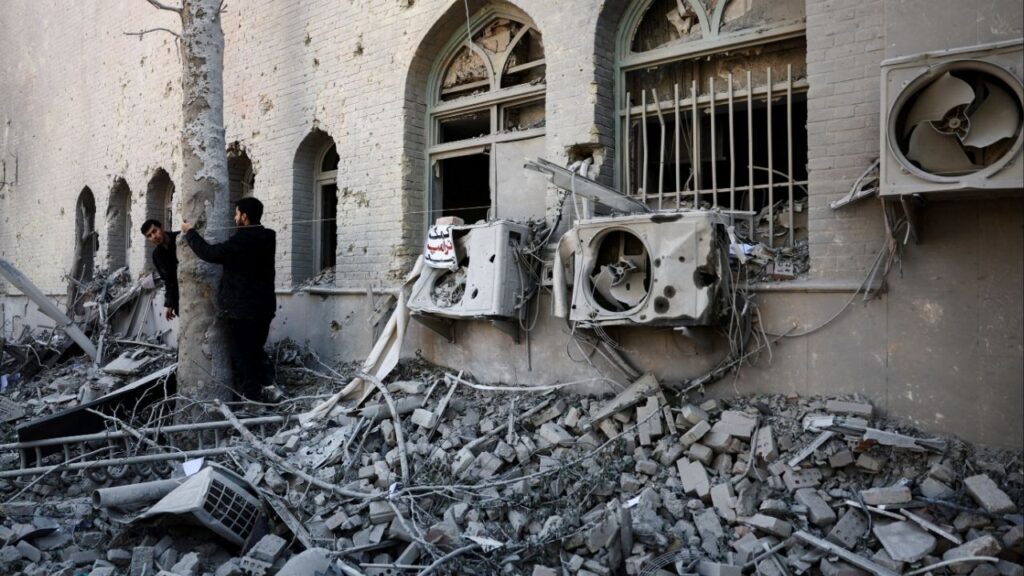 People stand amidst the rubble of a building of the Sharif University of Technology, which was damaged in a strike, amid the U.S.-Israeli conflict with Iran, in Tehran, Iran, April 7, 2026. Majid Asgaripour/WANA (West Asia News Agency) via REUTERS