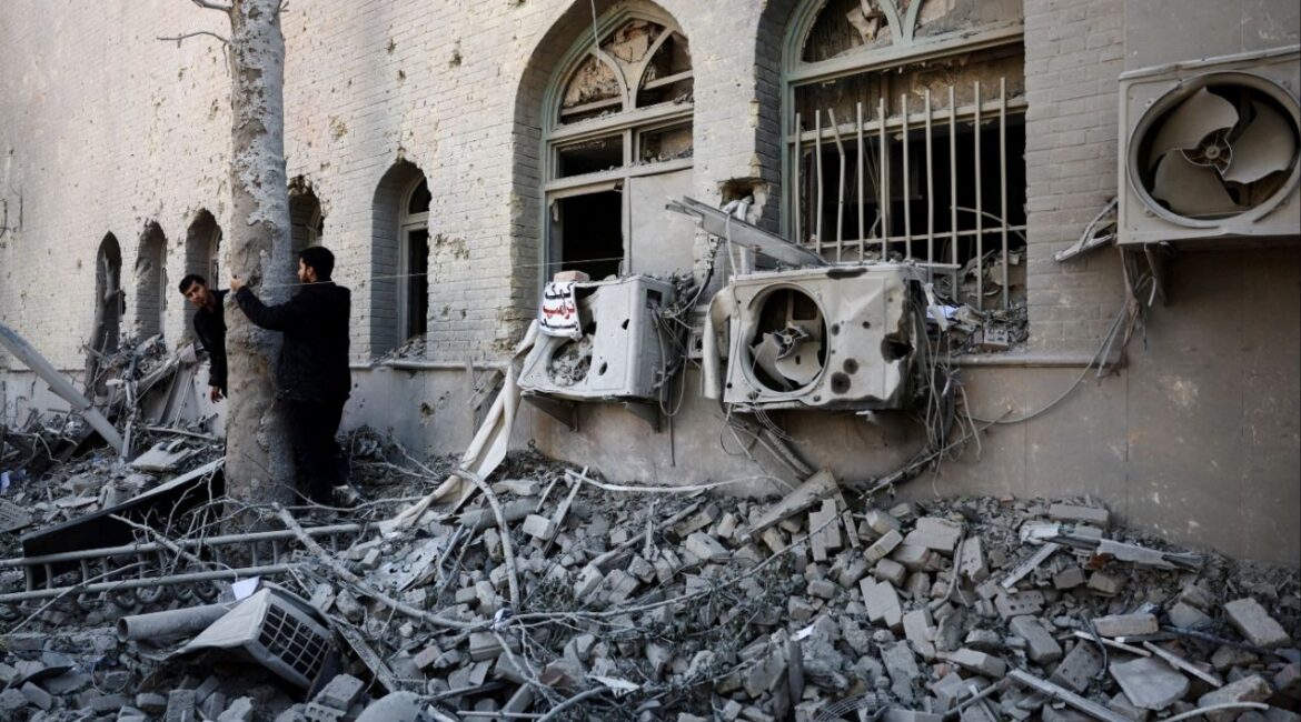 People stand amidst the rubble of a building of the Sharif University of Technology, which was damaged in a strike, amid the U.S.-Israeli conflict with Iran, in Tehran, Iran, April 7, 2026. Majid Asgaripour/WANA (West Asia News Agency) via REUTERS