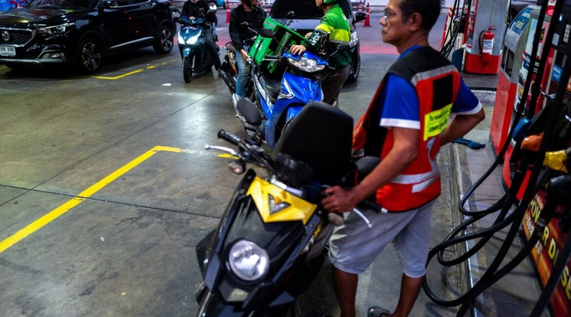 People with vehicles queue to fill up fuel at a gas station amid the U.S.-Israeli conflict with Iran, in Bangkok, Thailand, March 26, 2026. (Reuters/Athit Perawongmetha)